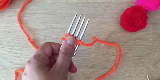 Cum să faci un pompon: începe să înfășori furculița cu fir